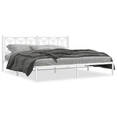 A white metal bed frame with a headboard and bedding.