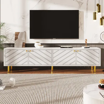 A modern living room scene featuring a white TV stand with gold accents and a large black television mounted on a marble-patterned wall.