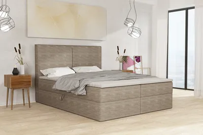 A bedroom scene with a bed, nightstand, and artwork.