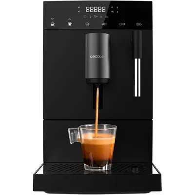 A black automatic coffee machine is brewing coffee into a glass mug.