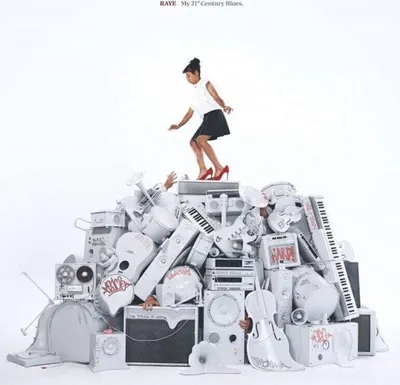 A woman stands on a pile of musical instruments, reaching upwards.