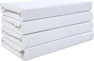 A stack of four white fitted sheets.