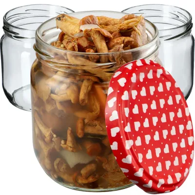 Three glass jars, one filled with preserved mushrooms, and a red lid with white hearts.