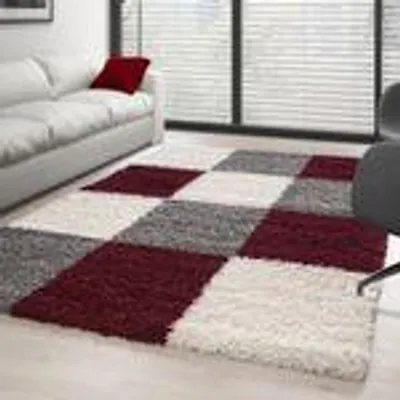 A living room scene with a sofa and a checkered rug.