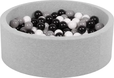 A close-up view of a light gray ball pit filled with black, white, and gray balls.