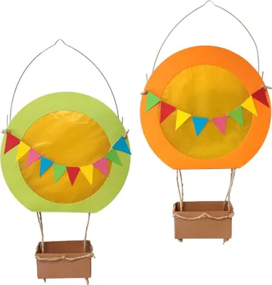 Two decorative hot air balloon crafts with baskets hanging below, decorated with colorful bunting.