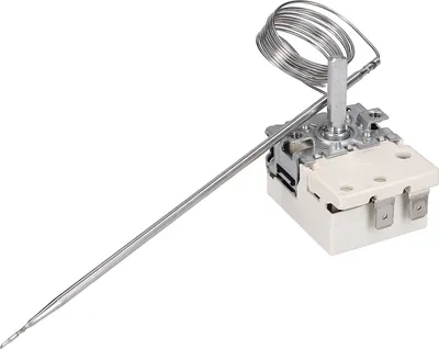 A close-up studio shot of a metal and white thermostat.