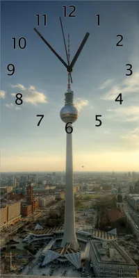 Produktbild von Wallario Design Wanduhr bedruckt, Größe 30 x 60 cm, Motiv: Fernsehturm Berlin mit Panoramablick über die Stadt