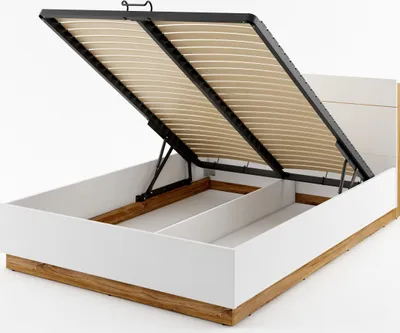 A bed frame with its storage compartment open, showing the lifting mechanism and the slatted base.