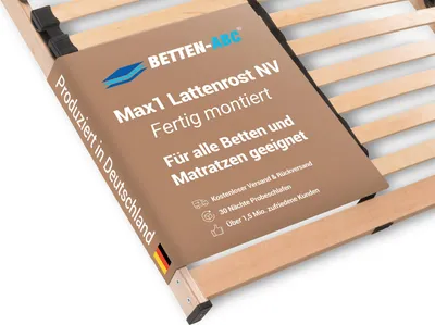 A close-up view of a wooden slatted bed base with a product information label wrapped around it.