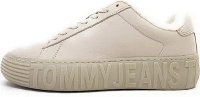 A side view of a beige sneaker with a thick sole.