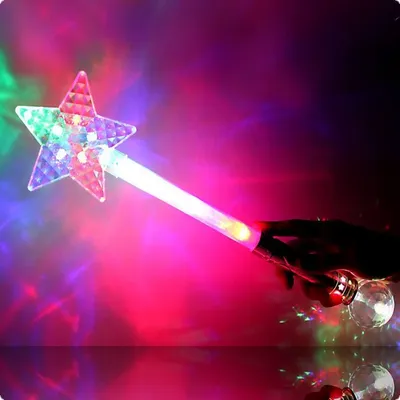 A hand holding a light-up star wand with colorful lights against a blurred, colorful background.