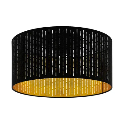 A black drum lampshade with a gold interior and a perforated pattern.