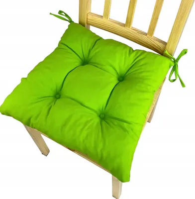 A bright green seat cushion on a wooden chair.