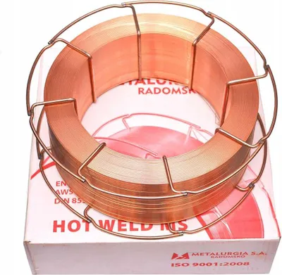 A spool of copper welding wire on a cardboard box.