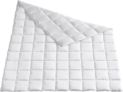 A white quilted comforter is shown laid out on a white background.