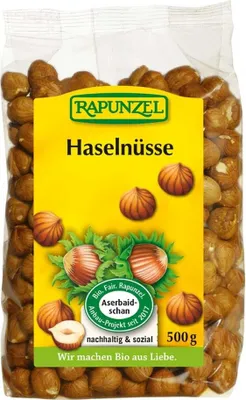A bag of Rapunzel hazelnuts with a prominent yellow label featuring product information and illustrations.