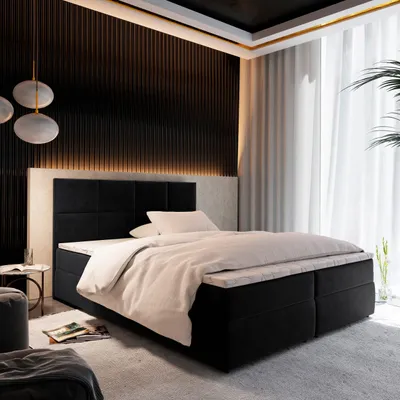 A luxurious bedroom with a large boxspring bed as the focal point.