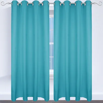 Two turquoise curtains hanging on a curtain rod in front of a window.