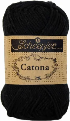 A ball of black yarn with a brown label.