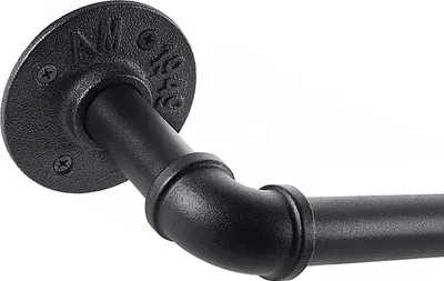 Close-up of a black metal pipe fitting and rod, likely part of a curtain rod or industrial pipework.