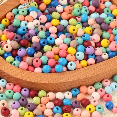 Produktbild von Runde Holzperlen in verschiedenen Farben, aus natürlichem Holz, zum Aufreihen – ideal zum Selbermachen von Schmuck – farbenfroh – 8 mm