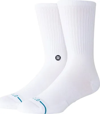 A pair of white crew socks with a small black logo on the side of one sock.