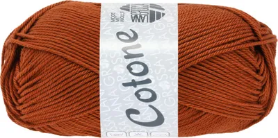 A ball of rust-colored yarn with a label.