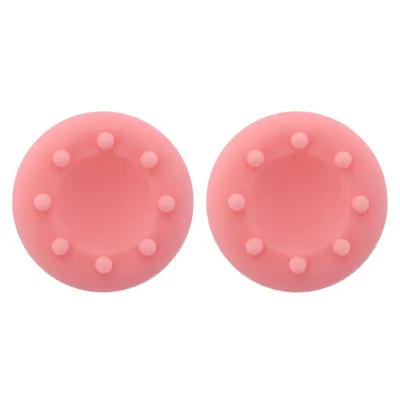 Two pink silicone controller thumb grips with raised dots.