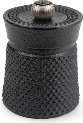 A black cast iron pepper mill with a textured surface and a silver knob on top.