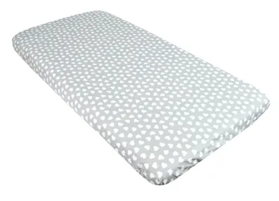 A baby crib sheet with a heart pattern is shown against a white background.