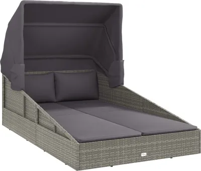 A grey rattan daybed with a canopy and cushions, shown against a white background.