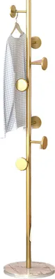 A gold coat rack with a marble base and a white garment hanging on it, isolated on a white background.