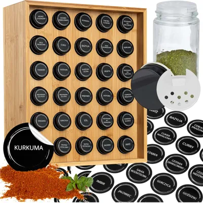 A spice rack with many spice jars and labels, along with a separate spice jar and loose spices.