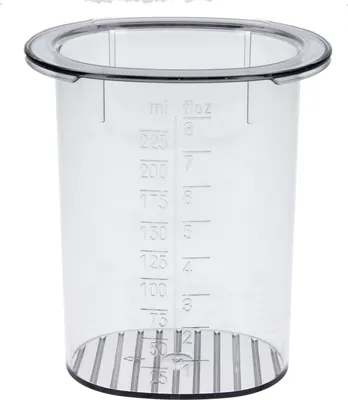 A clear, studio shot of a transparent measuring cup with markings for milliliters and fluid ounces.
