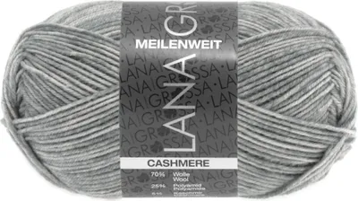 A ball of grey and white variegated yarn with a label.
