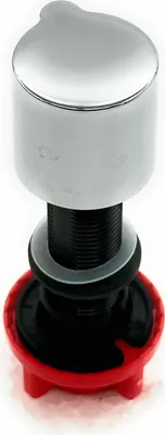 A close-up studio shot of a toilet flush button mechanism.