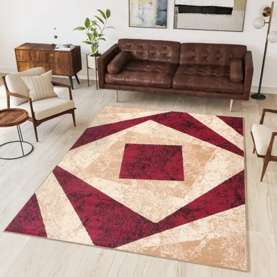 A living room scene with a rug, sofa, and armchair.