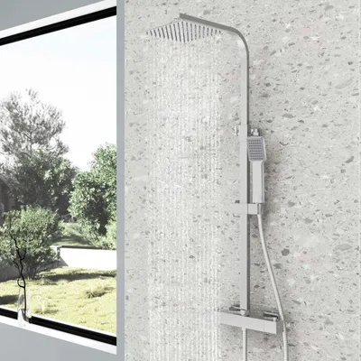 A modern shower system with a rainfall showerhead and handheld showerhead is shown in a bathroom with a textured wall and a large window overlooking a garden.