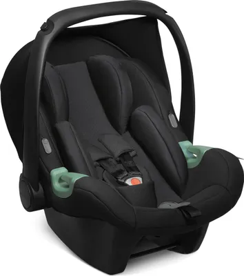 A black baby car seat with green accents, shown from a front-side angle against a white background.