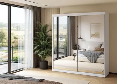 A modern bedroom with a large sliding door wardrobe with mirrored doors.