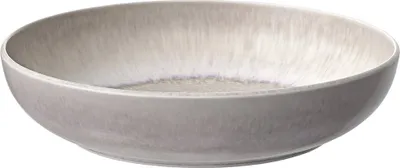 A close-up, studio shot of a single beige pasta bowl against a white background.