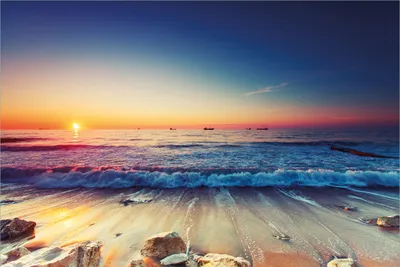 Produktbild von Wallario Premium Vliestapete Fototapete Sonnenuntergang am Meer mit Wellen am Strand in der Größe 400 x 267 cm, extra dick, wird in 5 Teilen geliefert