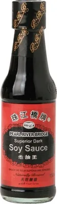 A bottle of Pearl River Bridge Superior Dark Soy Sauce against a white background.
