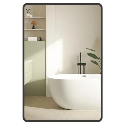 A modern bathroom with a freestanding bathtub, a vanity, and shelves reflected in a large wall mirror.