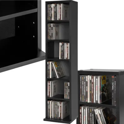 A black CD/DVD storage shelf unit filled with CDs and DVDs, shown from a slightly angled perspective.
