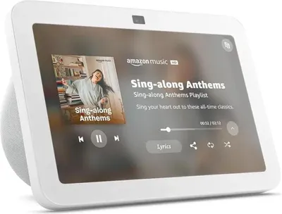 A smart display showing a music app interface with album art and playback controls.