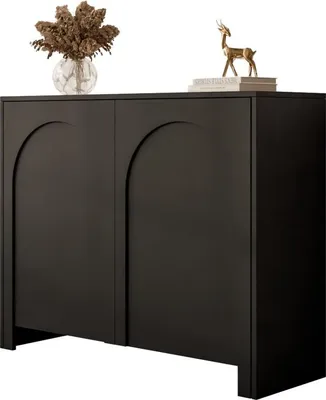 A black two-door cabinet with arched doors, decorated with a vase of dried flowers and a small golden deer figurine on top.
