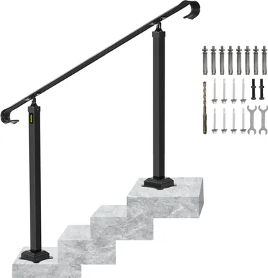 A black metal handrail for stairs is shown installed on a set of three simulated concrete steps. The handrail is angled, with two vertical posts supporting it. To the right of the handrail, a collection of hardware, including bolts, screws, a drill bit, an
