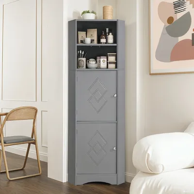 A gray corner cabinet with two open shelves and two closed cabinets, placed in a room next to a chair and a painting.